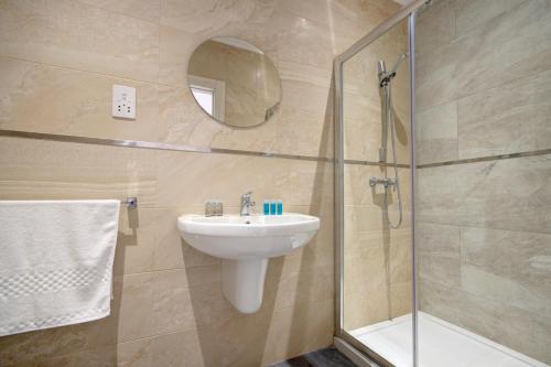 a bathroom with a sink and a shower at Enjoy Sunsets at Luxury 3BR APT in Mellieha Bay in Mellieħa
