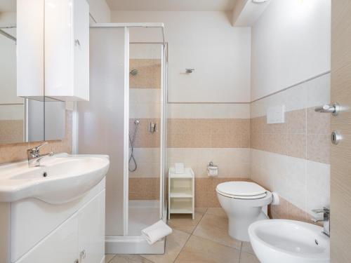 a bathroom with a toilet and a sink and a shower at B&B Giglio di Chia in Domus de Maria