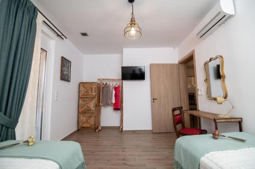 a room with two beds and a mirror at Stoa Luxury House with Unique Jacuzzi Room in Mourné