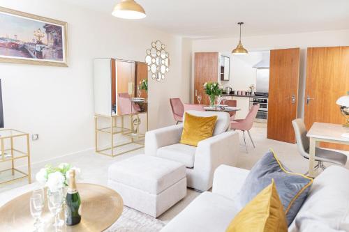 
a living room filled with furniture and a table at 10 Saint James - By Luxury Apartments in Cheltenham
