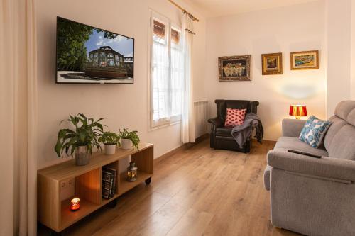 a living room with a couch and a chair at Can Prat Loft in Ripoll