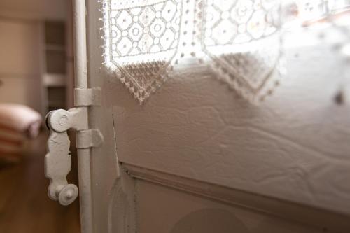 a close up of a door with a lace curtain at Can Prat Loft in Ripoll
