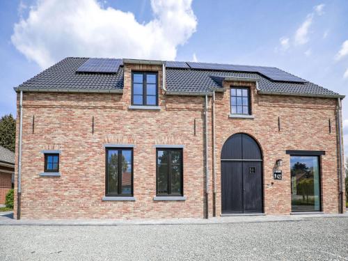 an image of a brick house with solar panels on the roof at Beautiful house in Flemish Ardennes for cyclists in Ronse