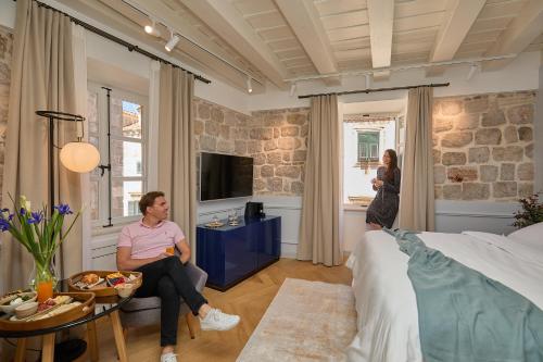 a man and a woman standing in a bedroom at Bota Palace in Dubrovnik