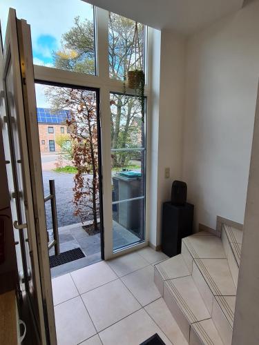 an empty room with a door open to a balcony at Le Vers'AYE in Aye