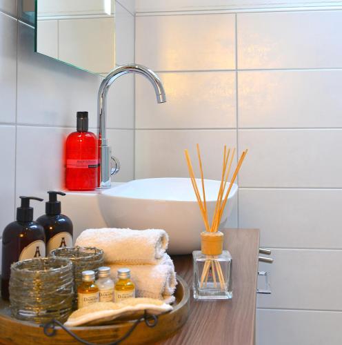a bathroom counter with a sink and a bath tub at Haus Margarete & Landhaus Karin in Zwiesel