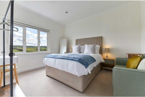 a bedroom with a large bed and a window at Host & Stay - Strathview in Hexham