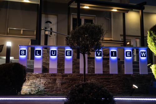a white fence with blue lights on it at Blue View Apartments in Kavala