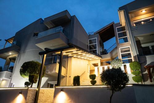 a large building with lights in front of it at Blue View Apartments in Kavala