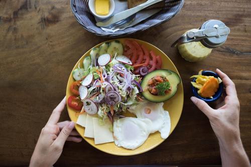 a plate of food with a salad and eggs on a table at Cafe de la Suerte in Pavones