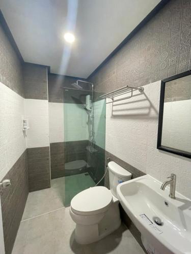 a bathroom with a toilet and a sink at Re-Live Resort in Ban Bang Phra