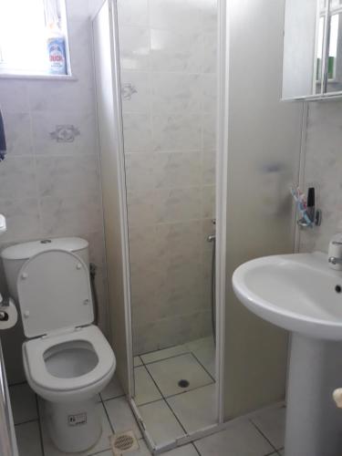 a bathroom with a shower and a toilet and a sink at Angel Villa in Strovlés