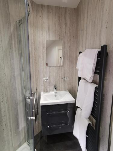a bathroom with a sink and a shower at Brooklands Guest House in Bowness-on-Windermere