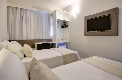 Uma cama ou camas num quarto em Go Inn Caratinga - MG