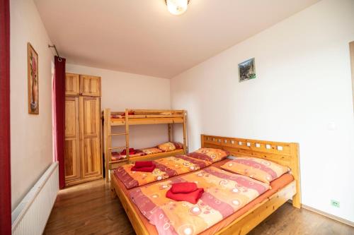 a bedroom with two beds and a bunk bed at Apartments Klinovec in Loučná pod Klínovcem