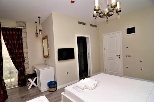 a bedroom with a bed with towels on it at Grand Alaçatı Butik Hotel in Alacati