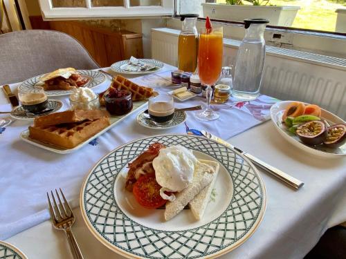 a table with plates of food on a table at Sans Souci Bed and Breakfast Luxe Heated Pool and Restaurant in Luzillé