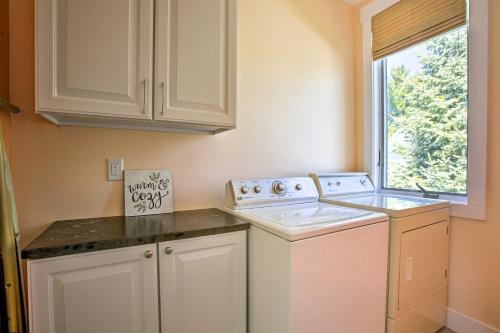 a kitchen with a washing machine and a window at Cozy and Urban Ludington Apt about 1 Mi to Lake Michigan in Ludington