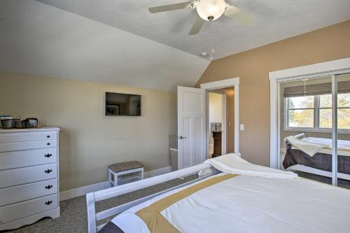 a bedroom with a bed and a ceiling fan at Cozy and Urban Ludington Apt about 1 Mi to Lake Michigan in Ludington