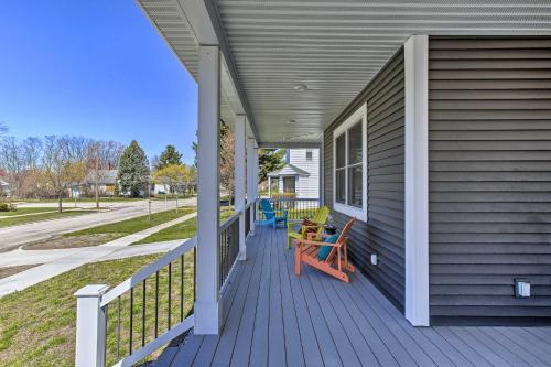 a porch with a wooden bench on a house at Cozy and Urban Ludington Apt about 1 Mi to Lake Michigan in Ludington