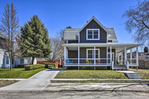 a gray house with a porch and a driveway at Cozy and Urban Ludington Apt about 1 Mi to Lake Michigan in Ludington