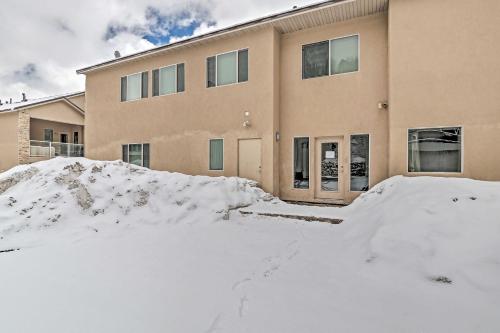 a house with snow in front of it at Luxe Brian Head Escape with Hot Tub and Mtn Views in Brian Head