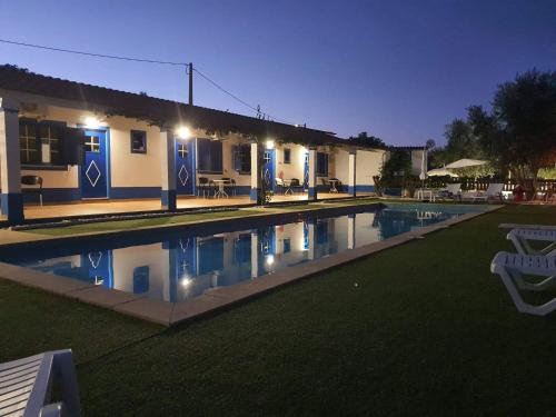 una piscina frente a una casa por la noche en Monte Família Ferreira en Vale de Açor