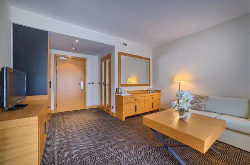 a living room with a couch and a table at Grand Nosalowy Dwór in Zakopane
