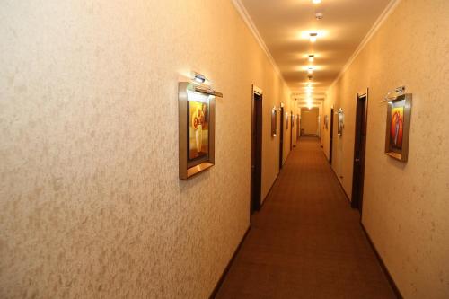 a hallway in a building with paintings on the walls at Luxe Lankaran Hotel in Lankaran