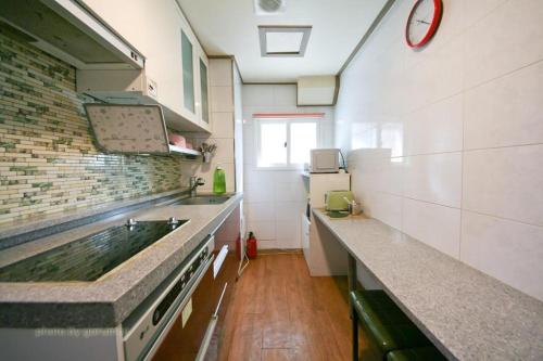 a kitchen with a sink and a counter top at Rodemhouse in Seoul