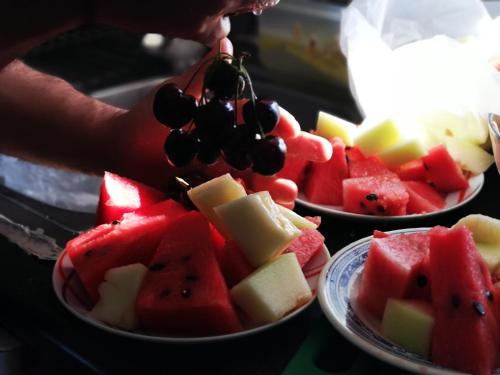 a person is eating a bunch of fruit at Ilios and Irene in Mastichari
