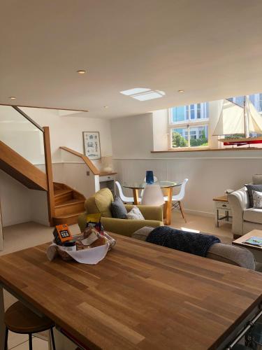 a living room with a couch and a table at The Old English Rooms in Falmouth