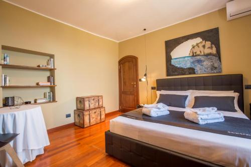 a bedroom with a large bed with towels on it at Montepagano 1137 in Montepagano