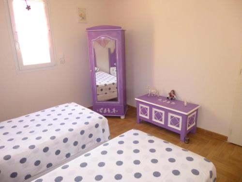 a bedroom with two beds and a mirror at Domaine de Flo ADULT a partir de 16 ans in Saint-Jean-de-la-Blaquière