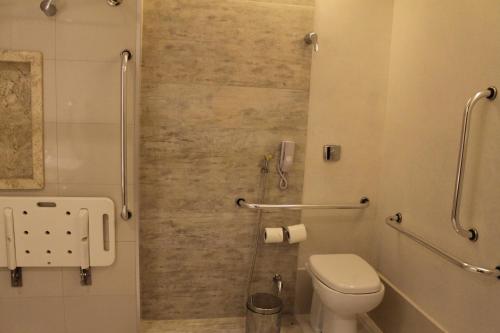 a bathroom with a toilet and a shower at Holiday Inn - Goiania, an IHG Hotel in Goiânia