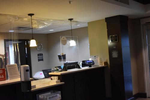 an office with a counter with a phone and a phone at Staybridge Suites Cranbury - South Brunswick by IHG in Cranbury