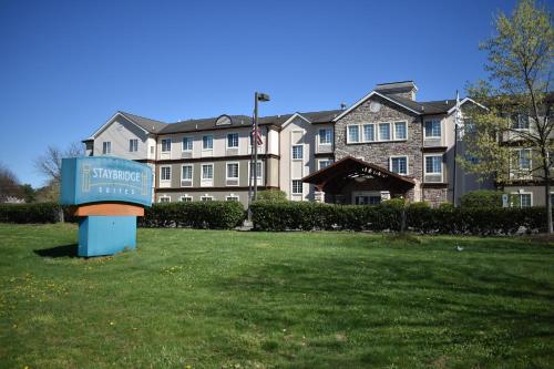 a sign in front of a large building at Staybridge Suites Cranbury - South Brunswick by IHG in Cranbury
