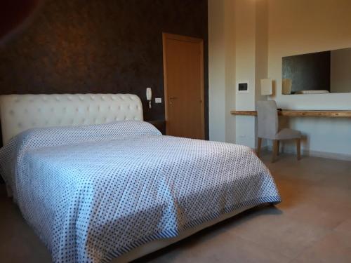 a bedroom with a bed with a blue and white blanket at Terra e colori in Gallipoli