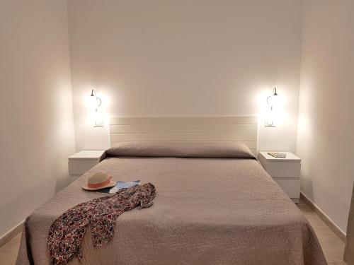 a bedroom with a bed with a hat on it at Mini Appartamenti Elba in Lacona