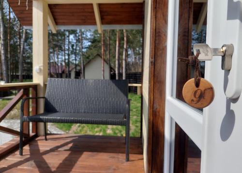a chair on the porch of a house at Комплекс На Дачі in Vyshpolʼ