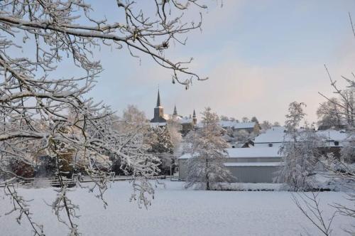 a city covered in snow with a town in the background at Vakantiestudio Ciney in Chapois