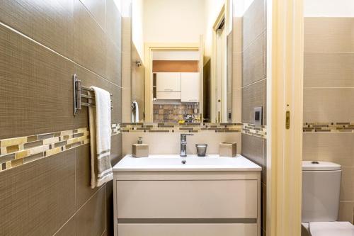 a bathroom with a sink and a toilet at La Casa Dei Ricordi in Letojanni