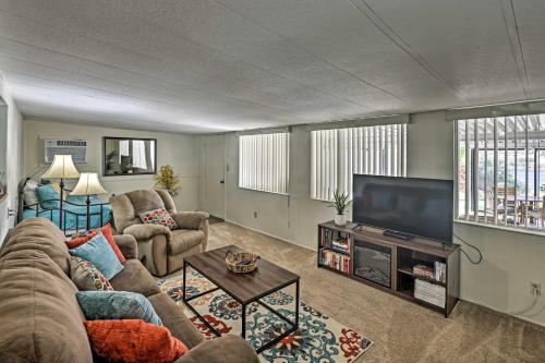 a living room with a couch and a flat screen tv at Restful Riverfront Retreat with Private Dock and Patio in Bullhead City