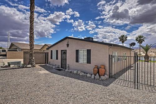 a house with two vases in front of a fence at Restful Riverfront Retreat with Private Dock and Patio in Bullhead City
