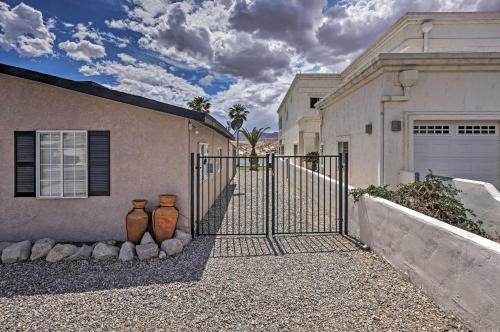 two vases sitting next to a gate in front of a house at Restful Riverfront Retreat with Private Dock and Patio in Bullhead City