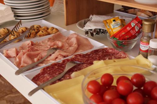 a table topped with lots of different types of food at Hotel Apis in Rimini