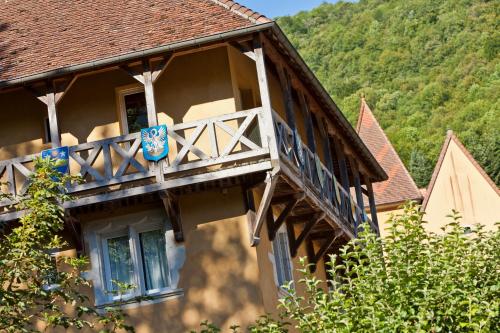a house with a wooden balcony on the side of it at Castel Damandre - Demeures & Châteaux in Arbois