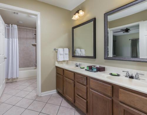 a bathroom with a sink and a mirror at Club Wyndham Smoky Mountains in Pigeon Forge