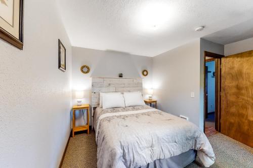 a bedroom with a bed and two night stands at Sweet Netarts in Tillamook