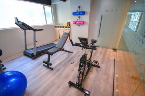 a gym with two exercise bikes and a gym ball at Kali Centro Mexico City in Mexico City